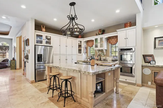 a large kitchen with a table and chairs