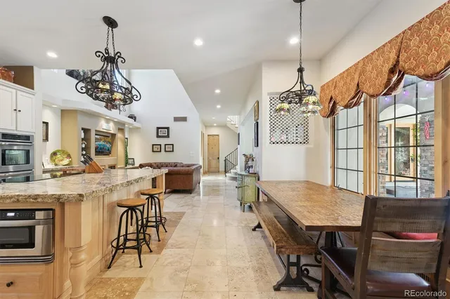 a view of a dining room with furniture and chandelier