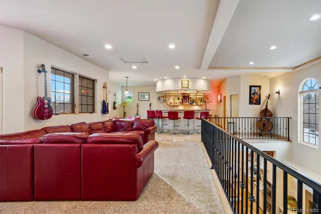 a living room with lots of furniture and a large mirror