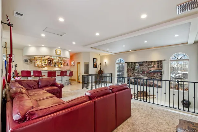 a room with pool table and windows