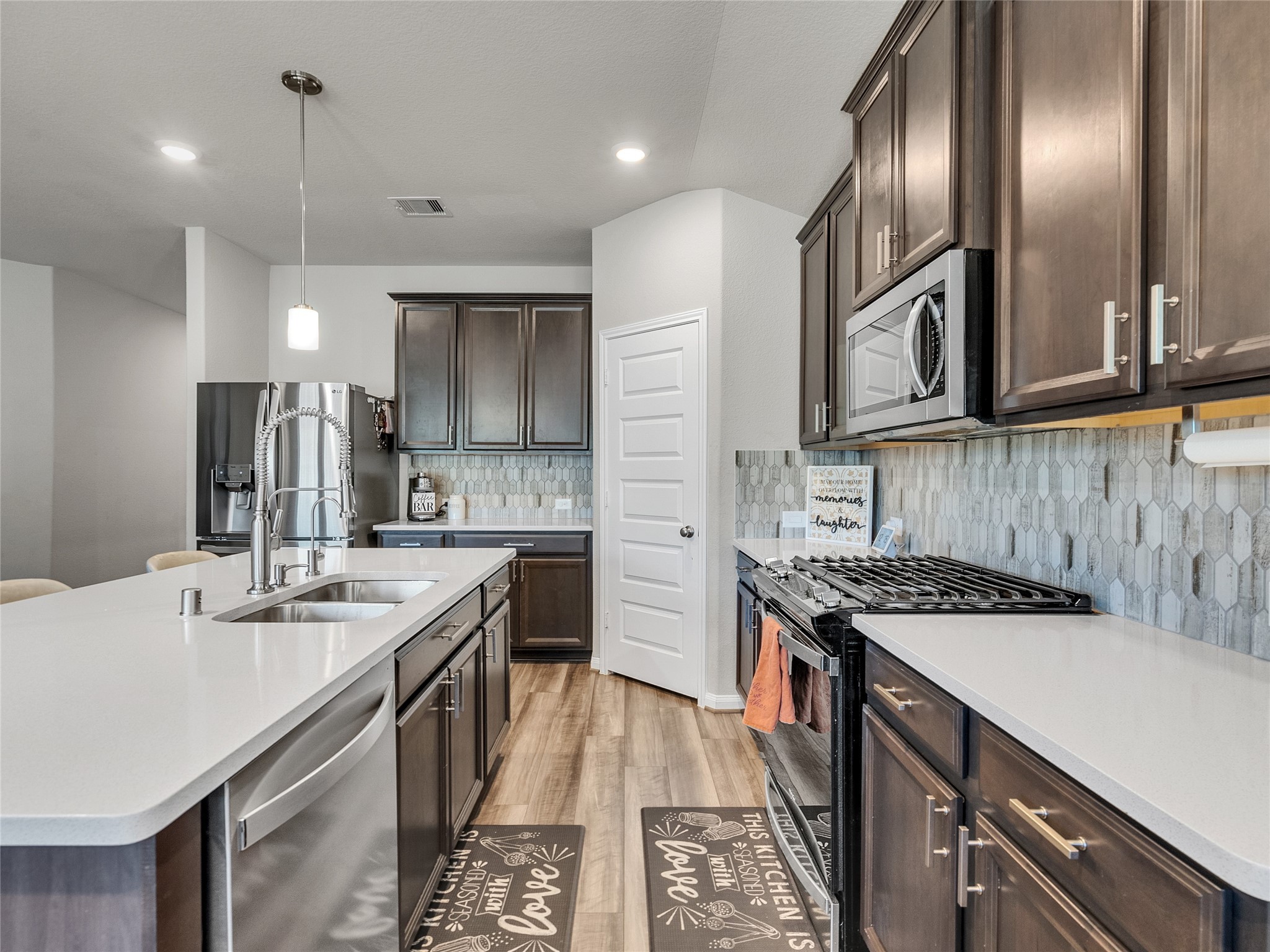 6006 Scott Way Rosenberg, TX 77471 - Photo 11 of 42 a kitchen with granite countertop a sink a counter space cabinets and stainless steel appliances