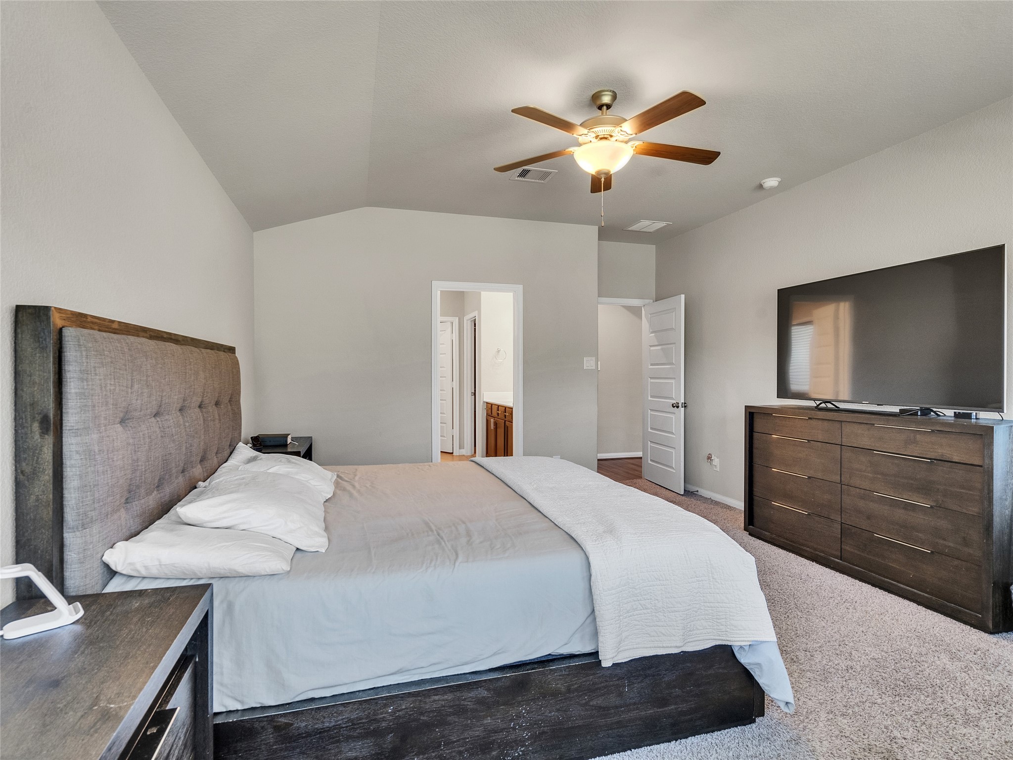 6006 Scott Way Rosenberg, TX 77471 - Photo 16 of 42 a bedroom with a bed and a chandelier