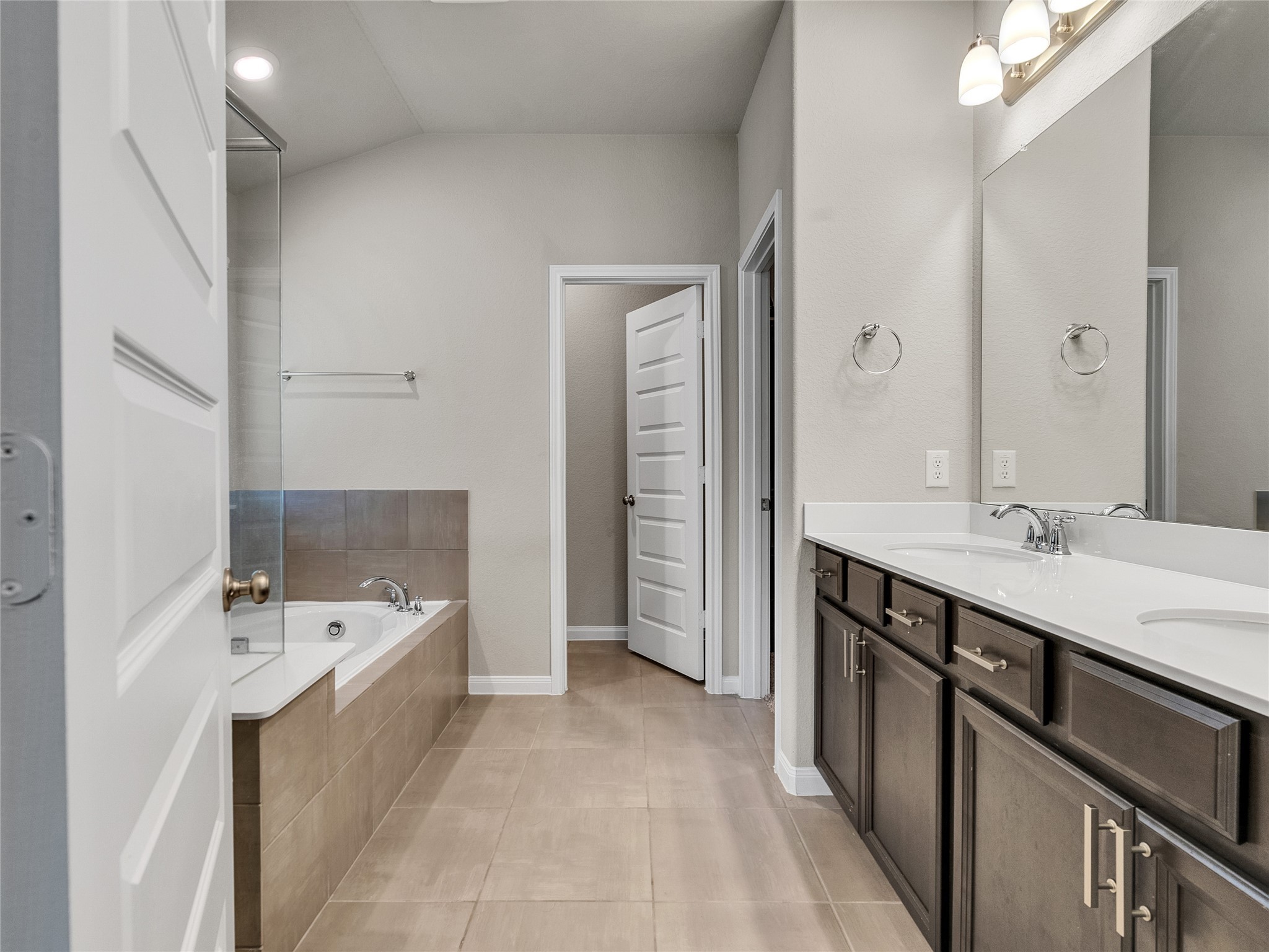 6006 Scott Way Rosenberg, TX 77471 - Photo 17 of 42 a bathroom with a tub sink double vanity granite tub shower and mirror