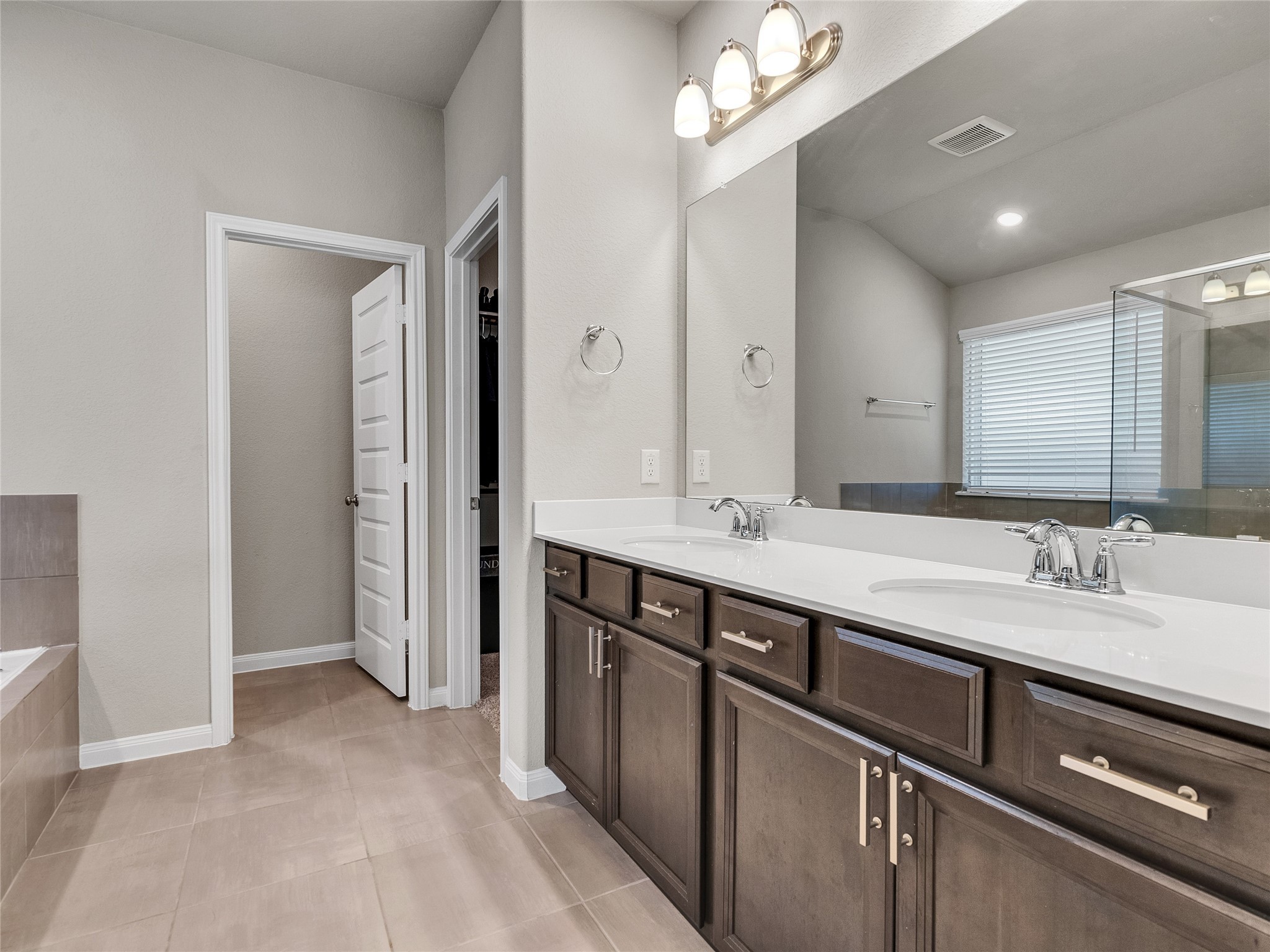 6006 Scott Way Rosenberg, TX 77471 - Photo 18 of 42 a spacious bathroom with a double vanity sink and a mirror