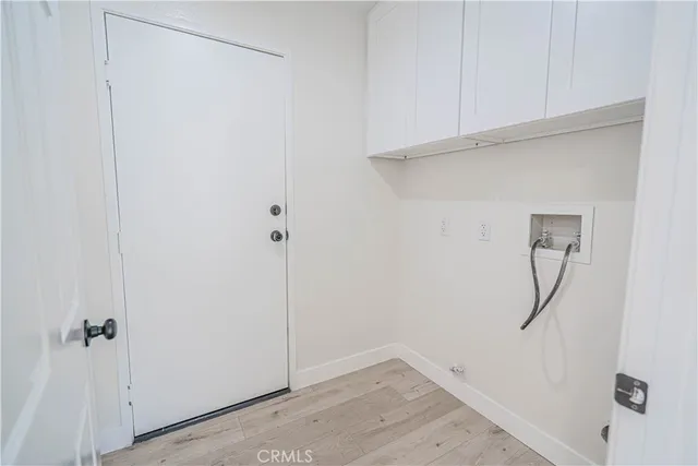 a view of a white house with chairs in front of it