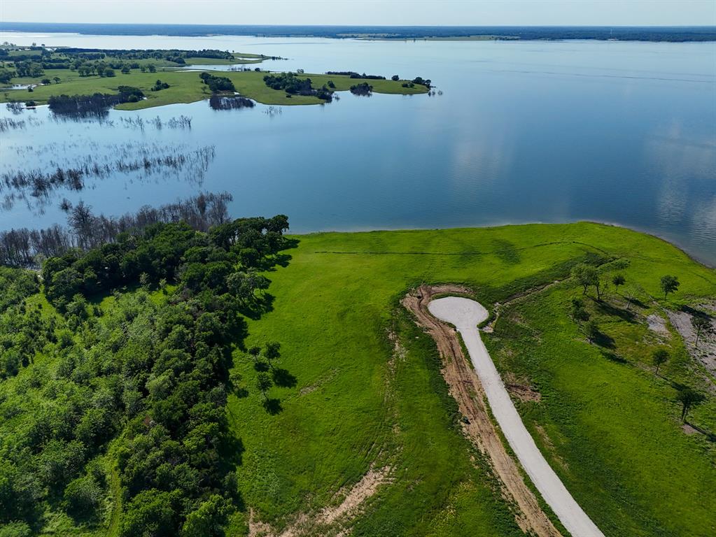 437 Harborside Terrace Windom, TX 75492 - Photo 5 of 28 a view of a lake with a yard and large trees