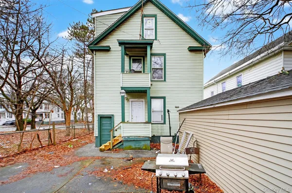 a backyard of a house with table and chairs