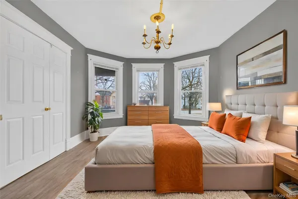 a bedroom with a large bed and a chandelier