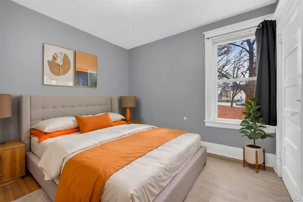 a bedroom with a bed and a painting on the wall