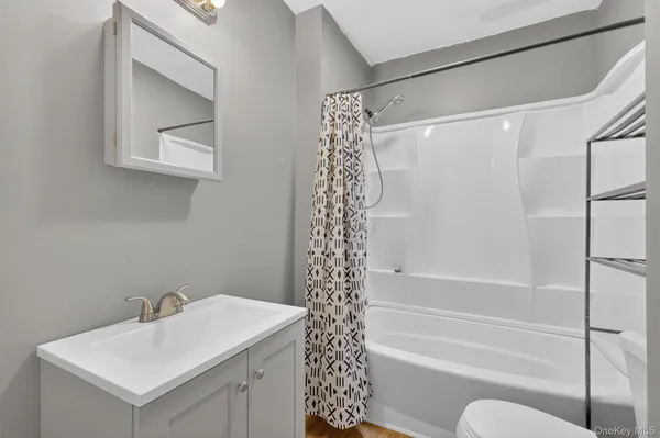 a bathroom with a bathtub a shower and a sink