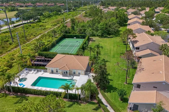 an aerial view of a house with a yard