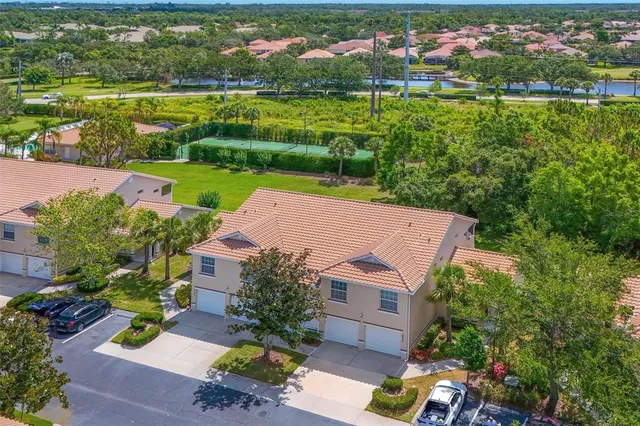 an aerial view of a house with a garden and trees