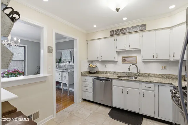 a kitchen with kitchen island white cabinets and white appliances