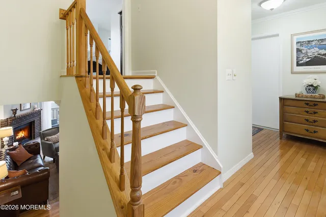 a view of entryway and hall with wooden floor