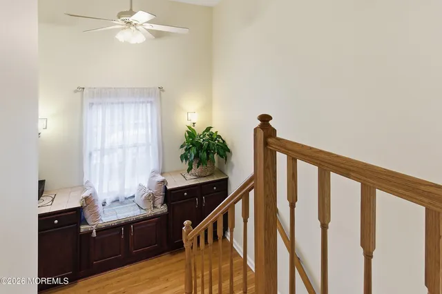 a view of a hallway view with wooden floor and staircase