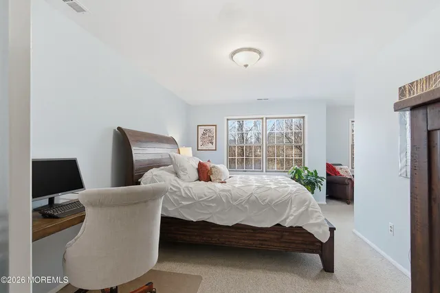 a bedroom with bed and window