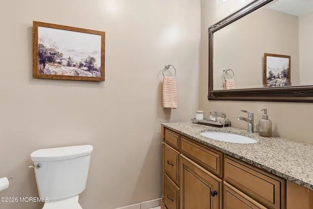 a bathroom with a toilet a sink and mirror