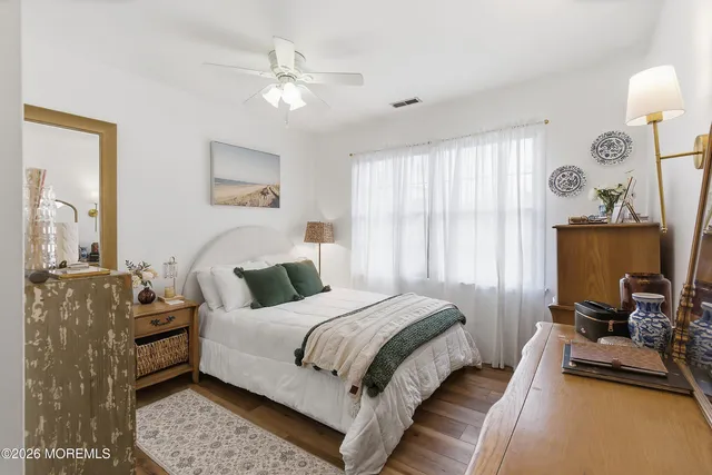 a bedroom with a bed couch and window