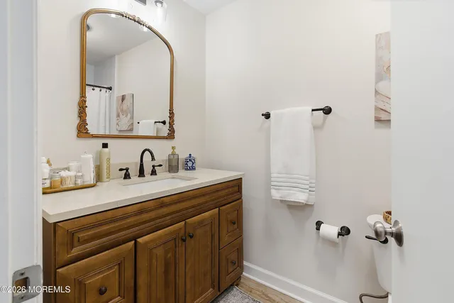 a bathroom with a sink vanity and a mirror