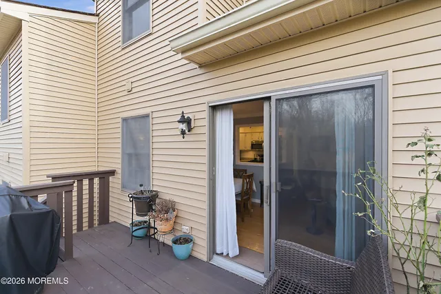a view of a balcony with wooden fence and floor