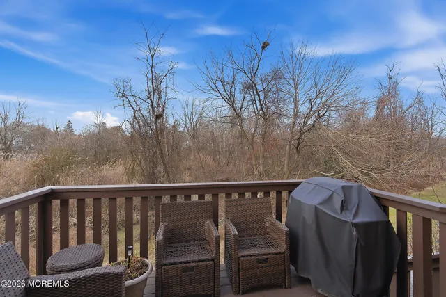 a view of a yard with trees in the background