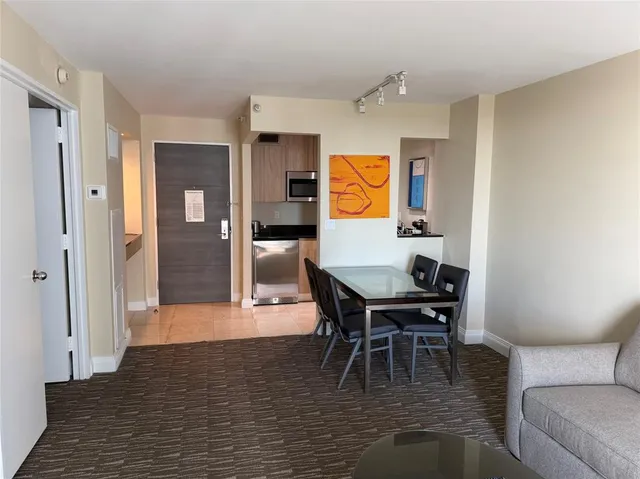 a kitchen with granite countertop white cabinets and stainless steel appliances