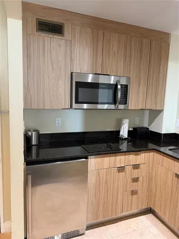 a kitchen with granite countertop a sink and cabinets