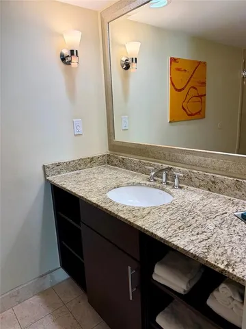 a bedroom with two beds and wooden floor