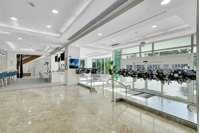 a room with pool table and windows