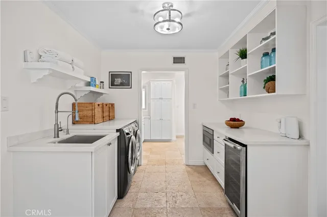 a kitchen with a refrigerator and a sink