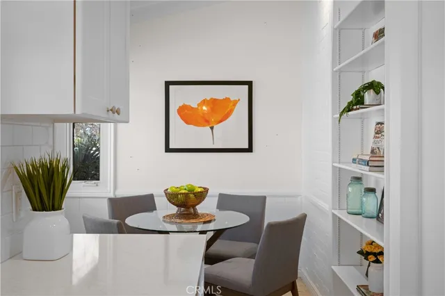 a dining room with furniture and potted plant