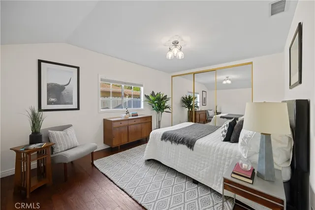 a bedroom with a large bed and a chandelier