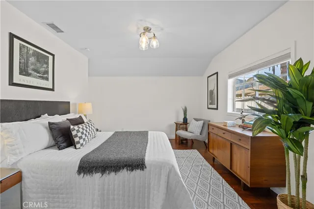 a bedroom with furniture and a potted plant