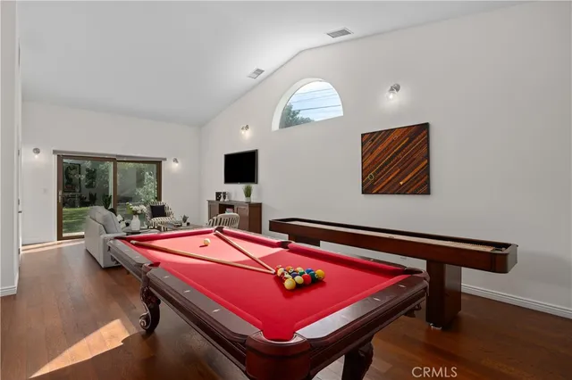 a room with furniture pool table flat screen tv and window