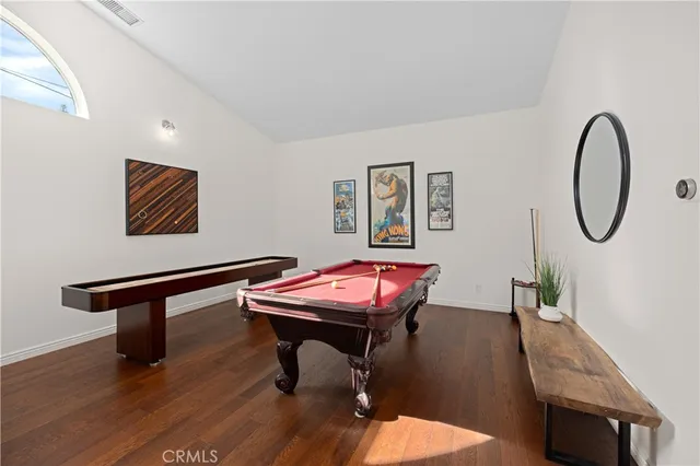 a living room with furniture a table and wooden floor