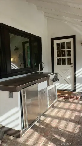 a view of a kitchen with a sink and a microwave