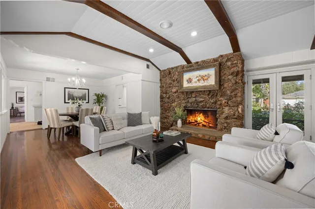 a living room with furniture large window and a fireplace