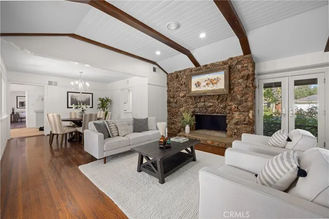 a living room with furniture wooden floor and a fireplace