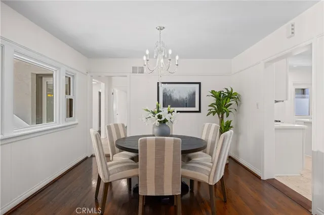 a view of a dining room with furniture wooden floor and chandelier