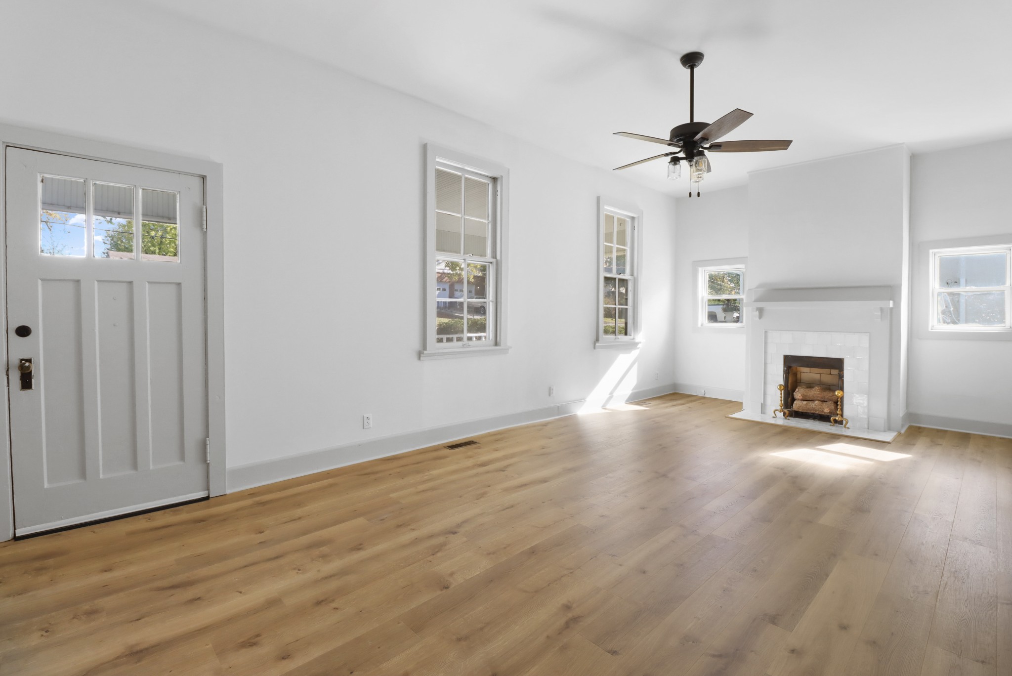 213 North Walnut Street Springfield, TN 37172 - Photo 3 of 20 a view of empty room with wooden floor and fireplace