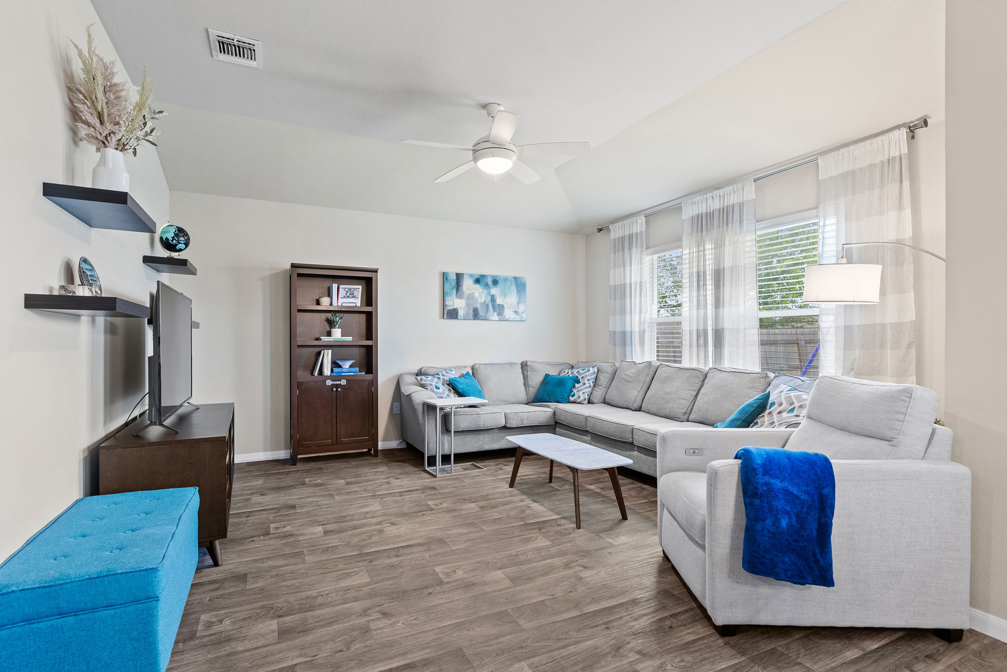 404 Cassandra Drive Hutto, TX 78634 - Photo 4 of 40 Living room with wood finished floors, ceiling fan, and vaulted ceiling