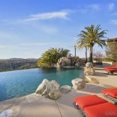 a view of swimming pool with lounge chair and lake view