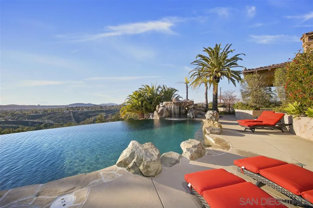 a view of swimming pool with lounge chair and lake view