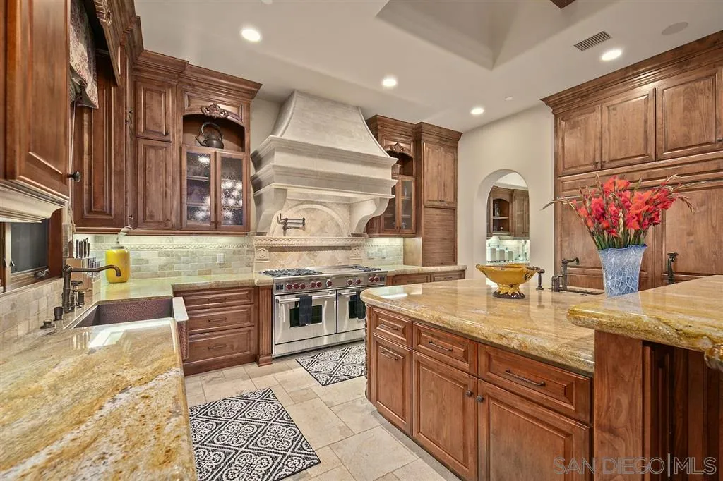 17087 Old Coach Road Poway, CA 92064 - Photo 11 of 25 a kitchen with stainless steel appliances granite countertop a sink stove and cabinets