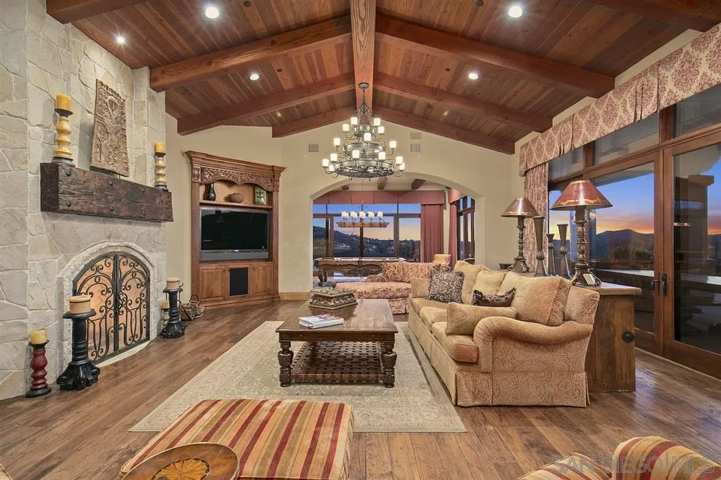 17087 Old Coach Road Poway, CA 92064 - Photo 13 of 25 a living room with furniture a fireplace and a chandelier