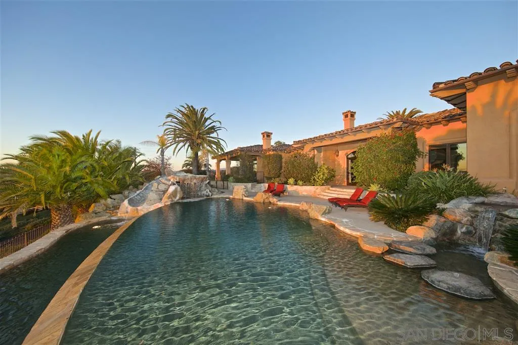 17087 Old Coach Road Poway, CA 92064 - Photo 4 of 25 a swimming pool with some trees in the background