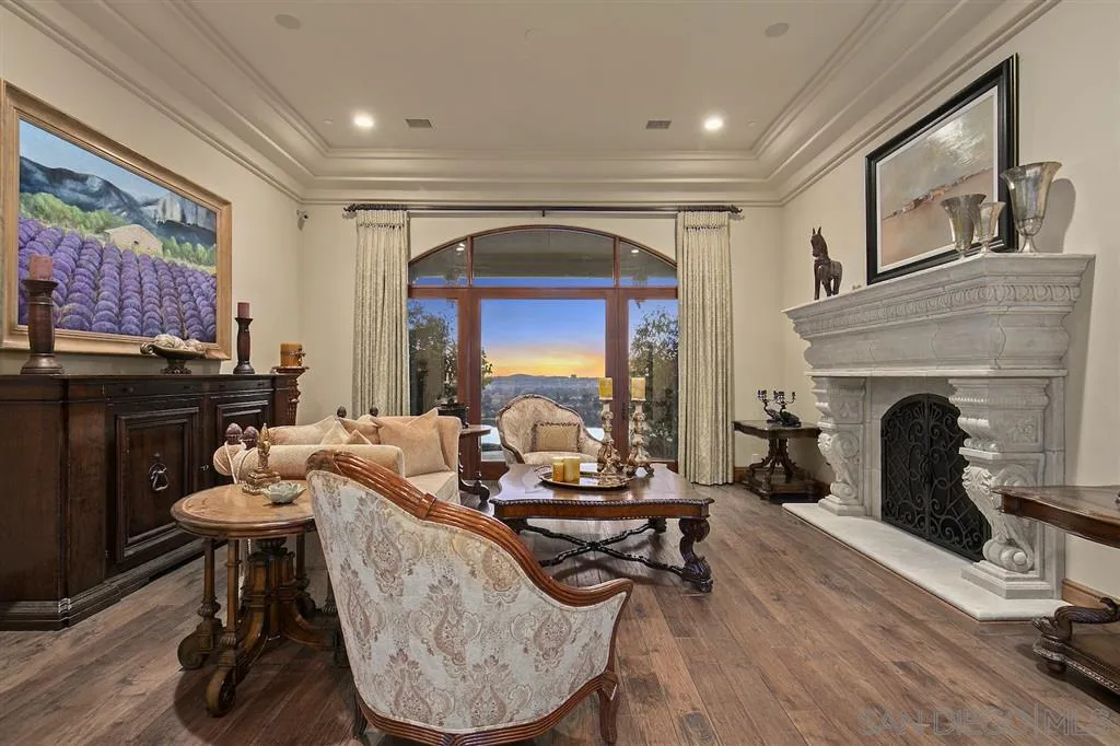 17087 Old Coach Road Poway, CA 92064 - Photo 8 of 25 a living room with furniture a fireplace and a flat screen tv