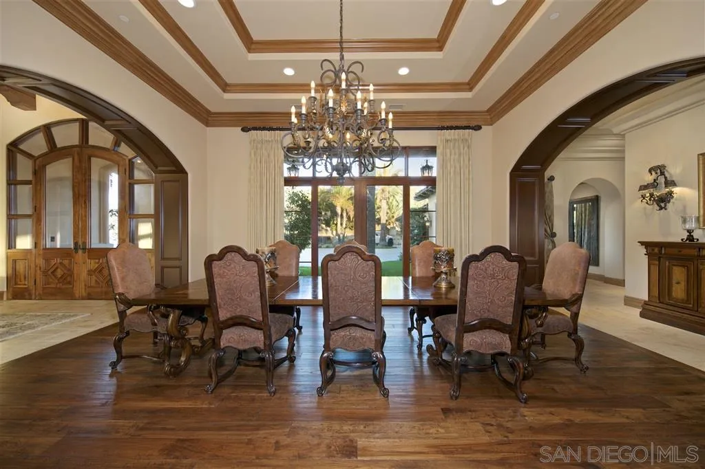 17087 Old Coach Road Poway, CA 92064 - Photo 9 of 25 a view of a dining room with furniture a chandelier and wooden floor