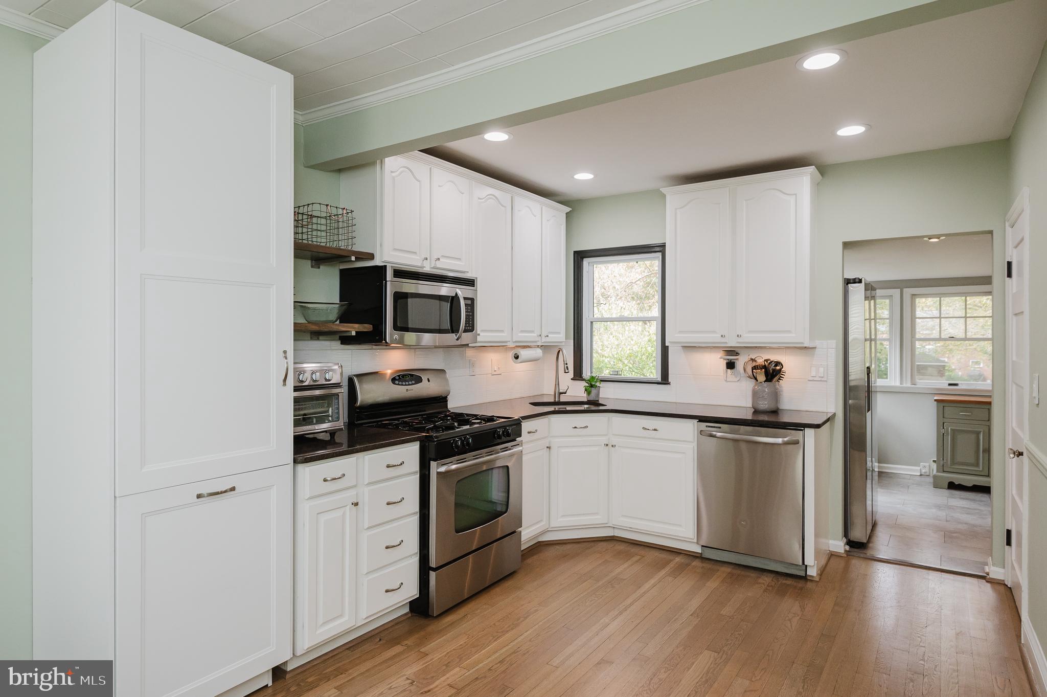 616 Sudbrook Road Baltimore, MD 21208 - Photo 16 of 58 a kitchen with granite countertop a sink cabinets and stainless steel appliances