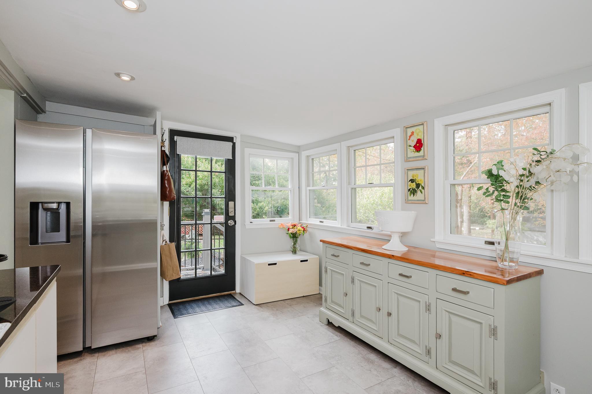616 Sudbrook Road Baltimore, MD 21208 - Photo 22 of 58 a large white kitchen with a refrigerator a sink stainless steel appliances and cabinets